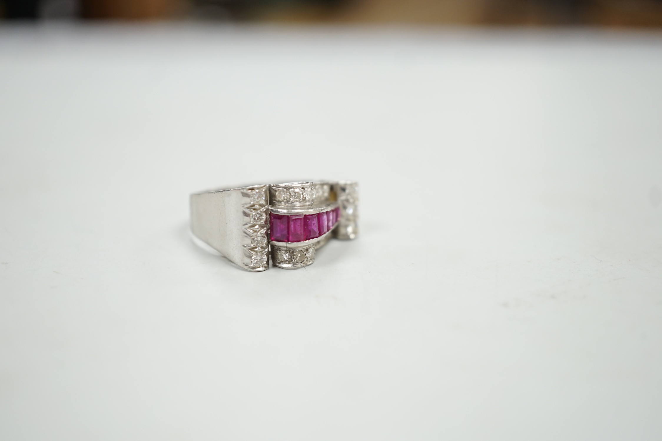 A 1950's? white metal, graduated ruby and diamond cluster set cocktail ring, size Q, gross weight 9.1 grams.